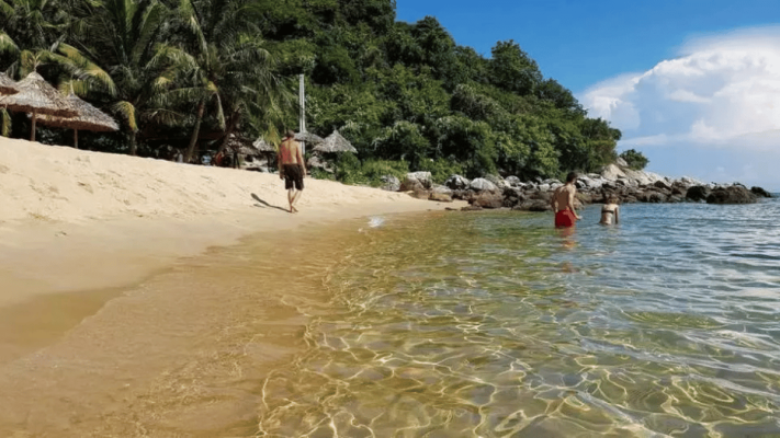 Swimming and playing on the white sand beach at Cham Island